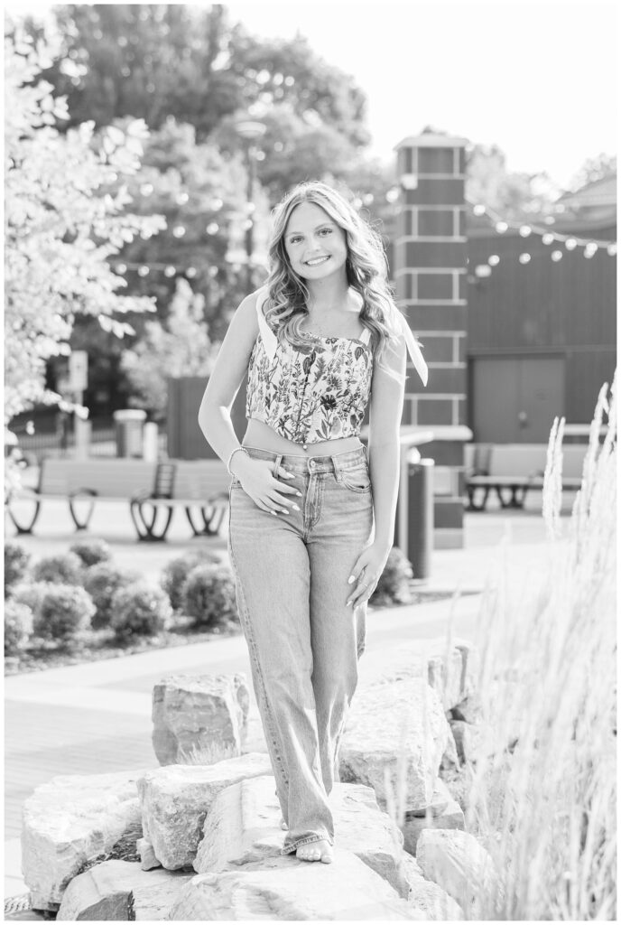high school senior posing in jeans in a park in Fremont, Ohio
