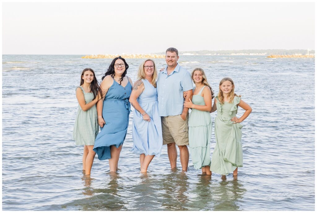large family posing in the water at East Harbor State Park in Ohio
