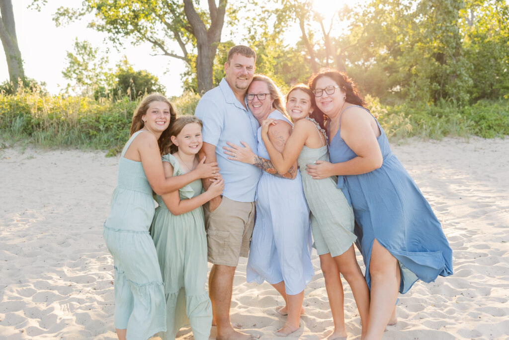 family all hugging each other on the beach at East Harbor State Park