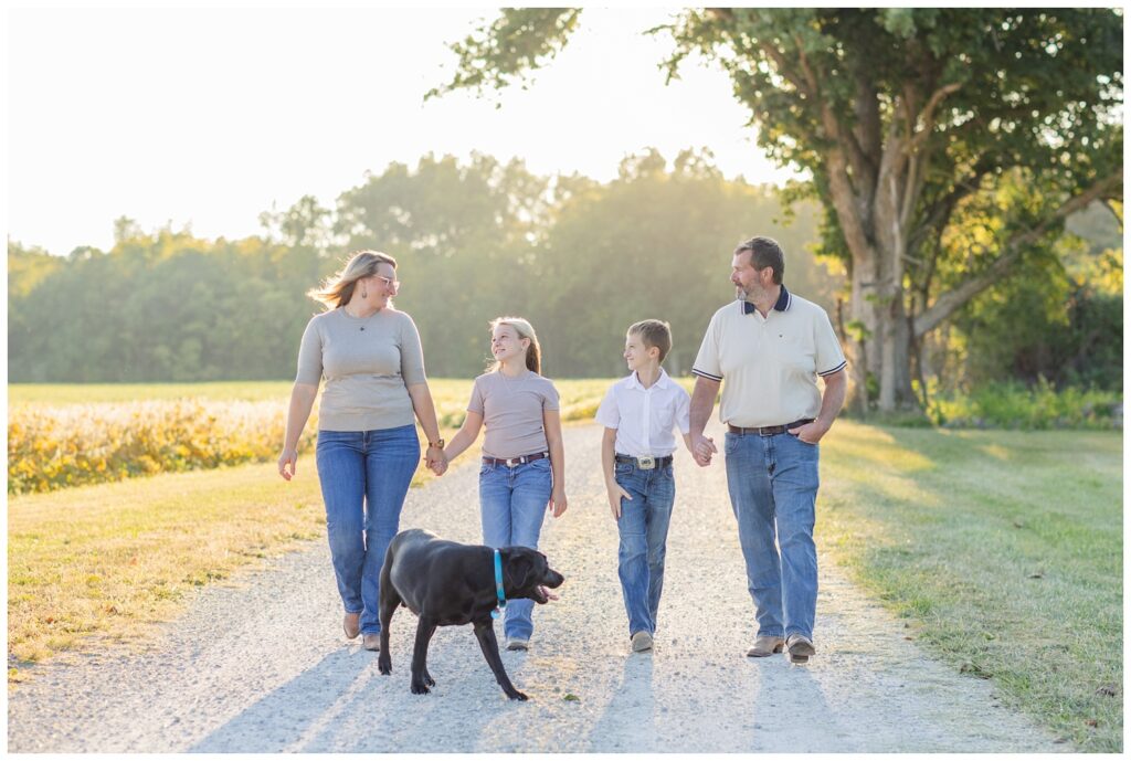 family walking on a gravel road at their farm in Tiffin, Ohio for portrait session