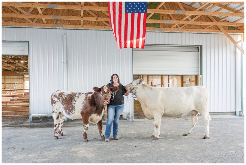 senior girl holding her cows inside white barn in Sandusky, Ohio