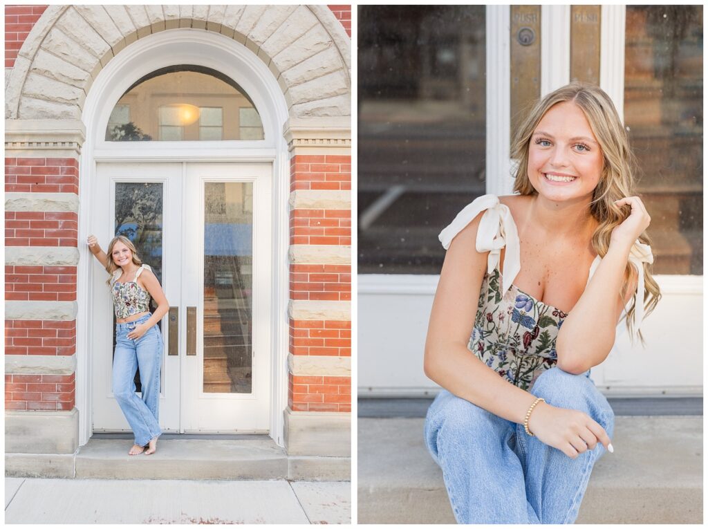 senior girl posing against white doors and brick building in Fremont, Ohio