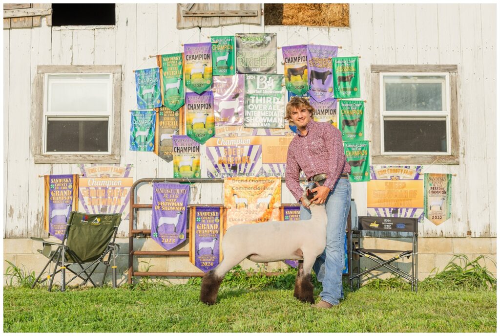 senior posing with one of his goats for livestock session in Fremont, Ohio