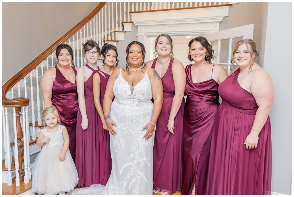 bride posing with her party in the foyer of the Christy House wedding venue