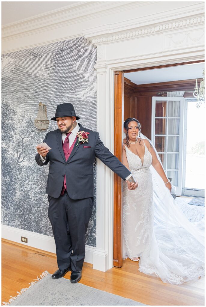 bride and groom have first touch around the corner of a hallway in Fremont, Ohio