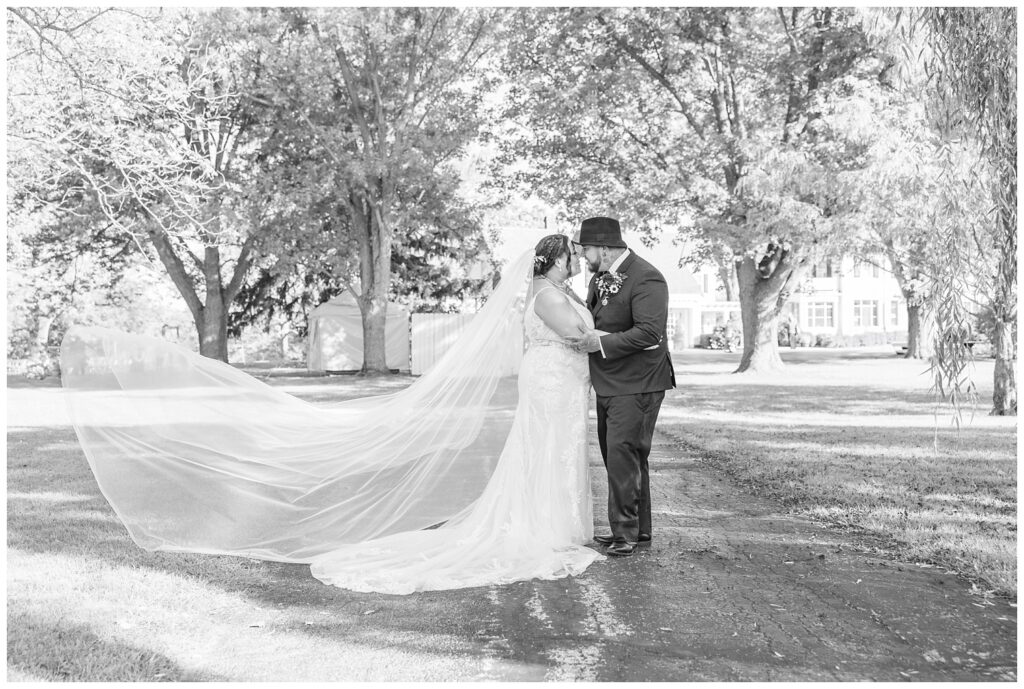 wedding couple posing together on the driveway of the Christy House
