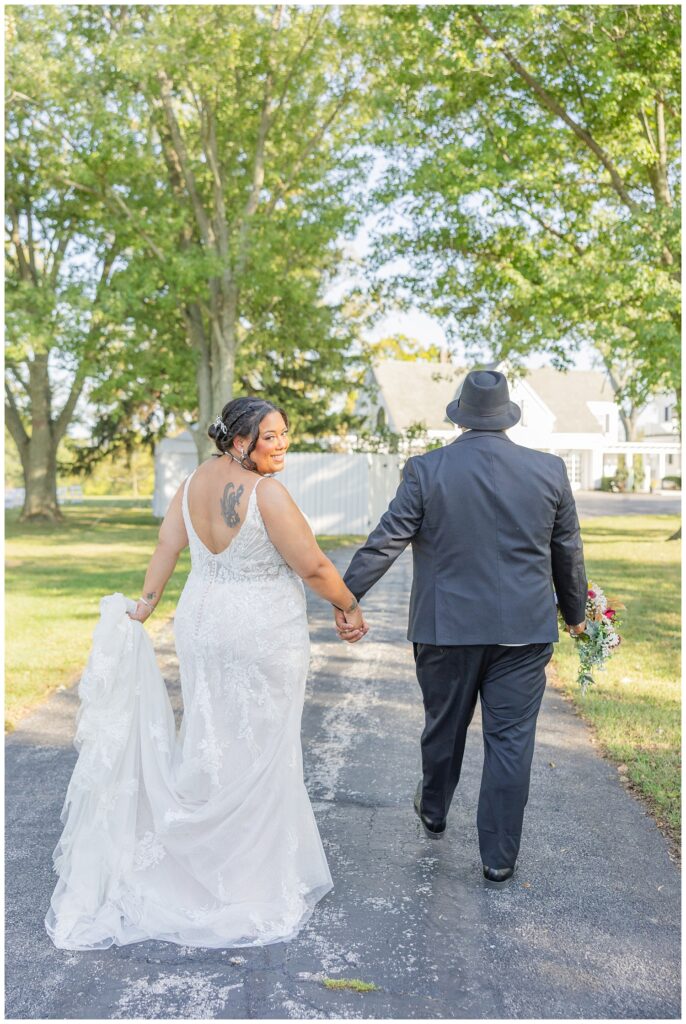 bride and groom walking away down the driveway of the Christy House venue