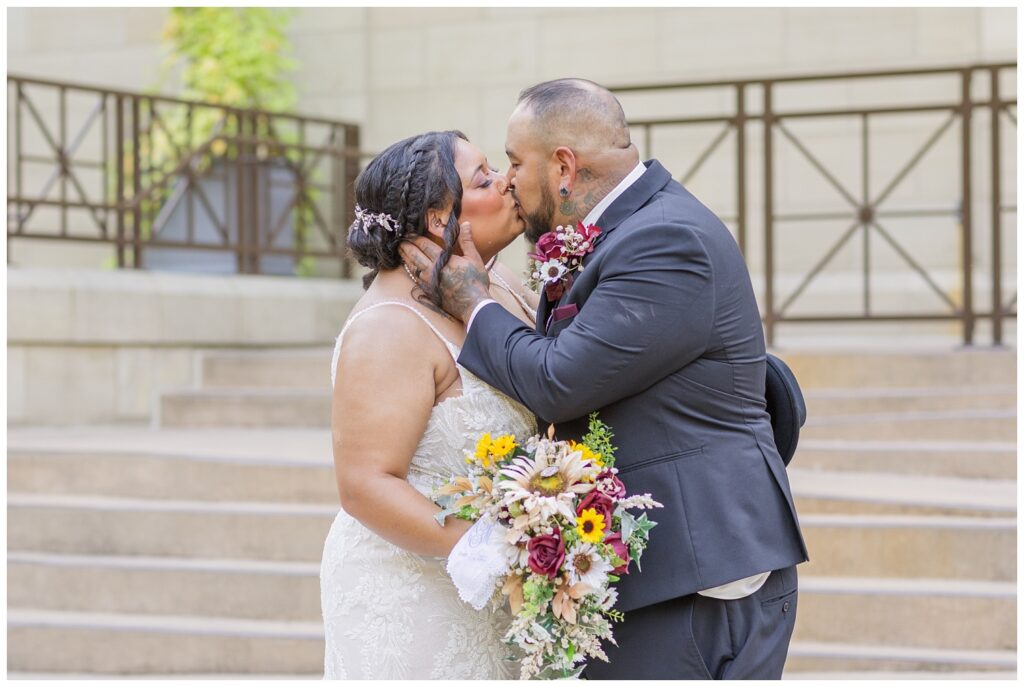 wedding couple sharing a kiss on the ramps of the Hayes Center in Fremont, Ohio