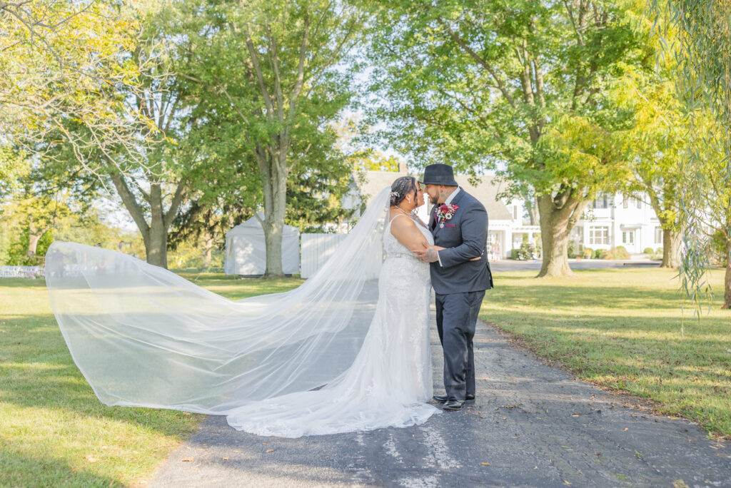 bride and groom holding each other on the driveway at the Christy House