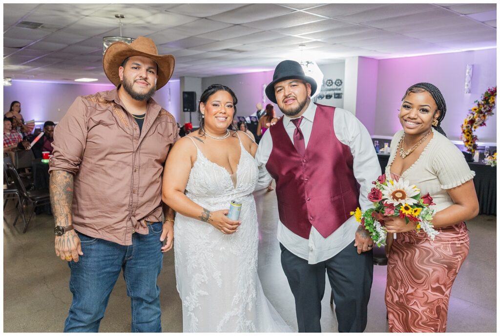 bride and groom posing with wedding guests during the reception in Fremont, Ohio