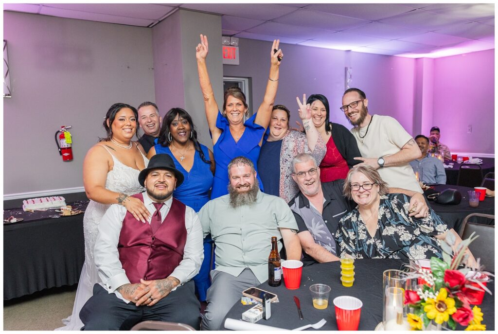 bride and groom cheering with family at a Victor's Center wedding reception