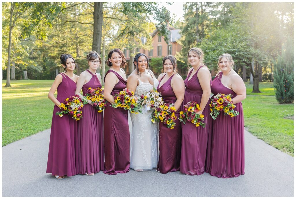 all of the bridal party posing on the driveway in front of the presidential house at Hayes Center