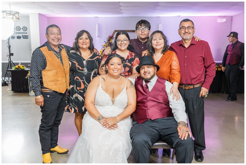 guest portraits with the bride and groom sitting in the middle of the room