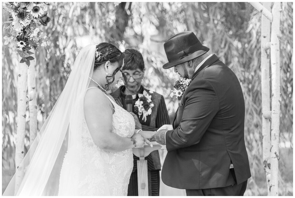 wedding couple exchanging rings outside at the Christy House venue