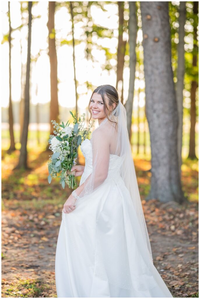 bride holding the side of her dress and walking away holding her bouquet