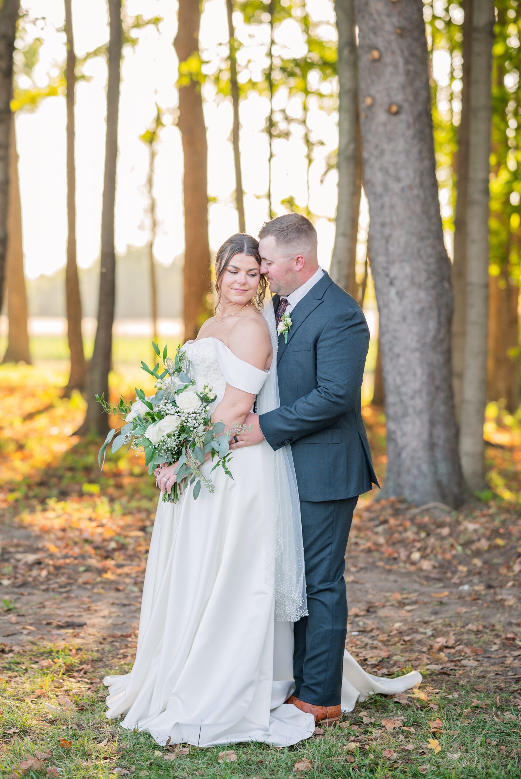 wedding couple posing in the woods for portraits near the Octagon House