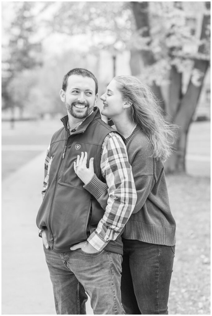 woman hugging her fiancée from behind at engagement session at Heidelberg University