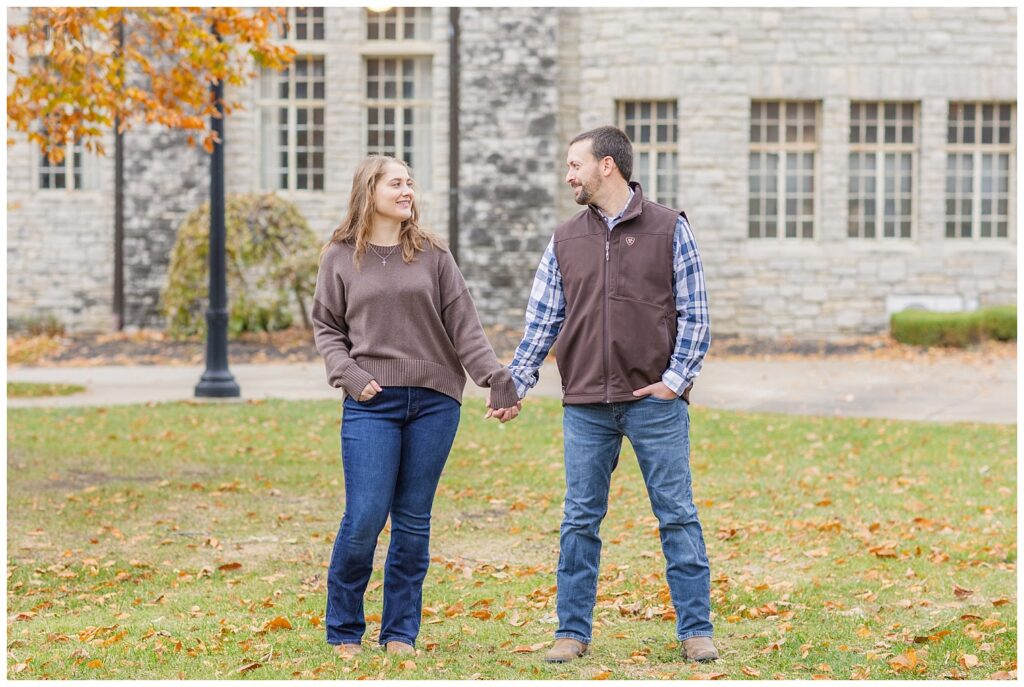 engaged couple holding hands on the campus of Heidelberg University in Tiffin, Ohio