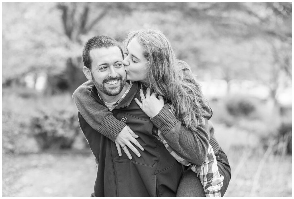 man giving his fiance a piggyback ride during their engagement session at Heidelberg University