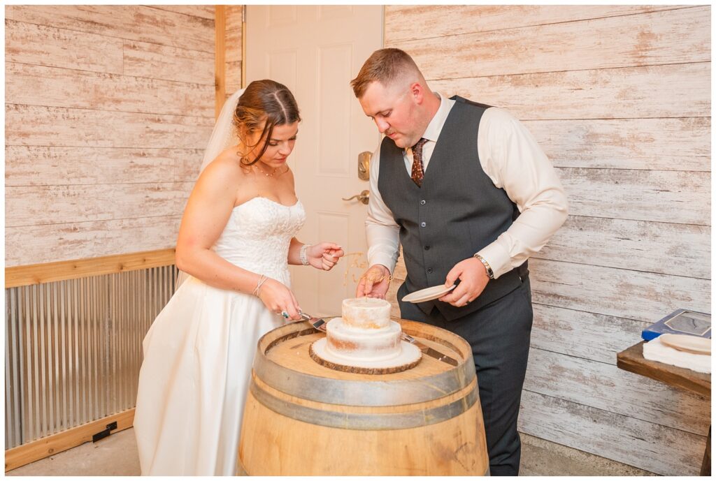 bride and groom cutting their cake on a tall wooden barrel in Fremont, Ohio