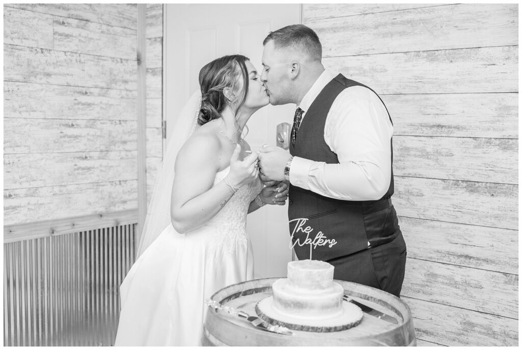 bride and groom kissing after eating wedding cake at the Octagon House in Tiffin, Ohio