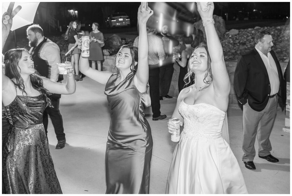 bride and bridesmaids singing and dancing on the outside dance floor at the Octagon House