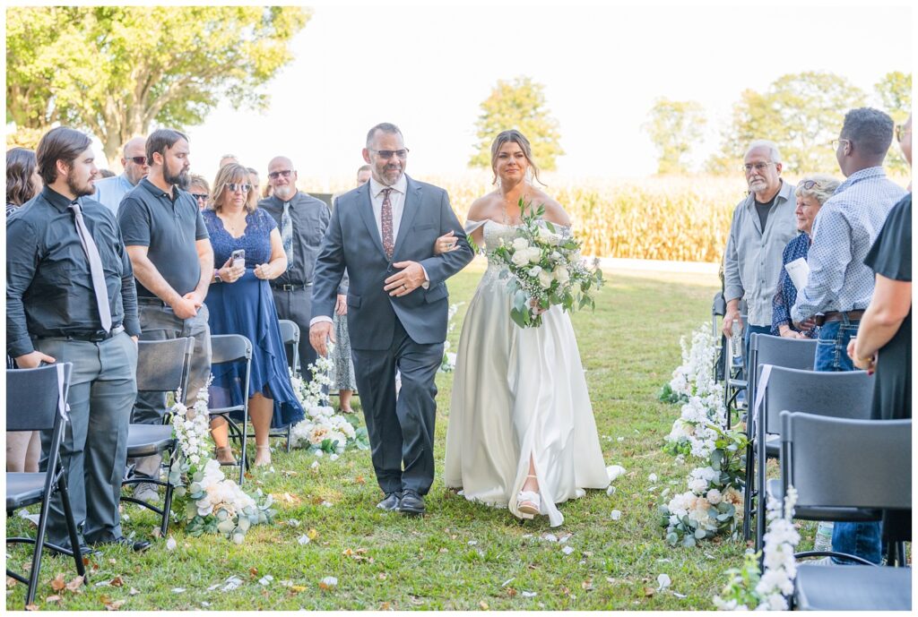 bride's dad walking her down the aisle at fall ceremony in Tiffin, Ohio