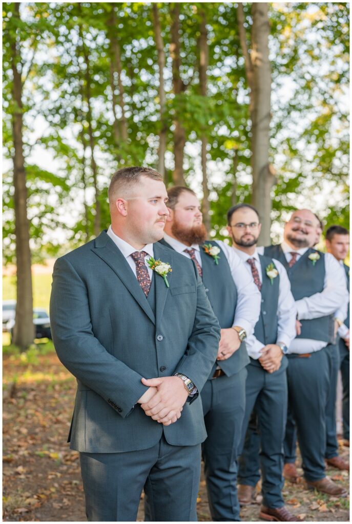 groom looking at the bride coming down the aisle with her dad outside in Fremont, Ohio