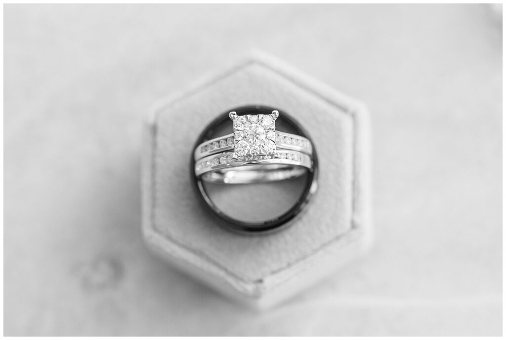 bride and groom rings sitting up together on a ring box for wedding flat lay