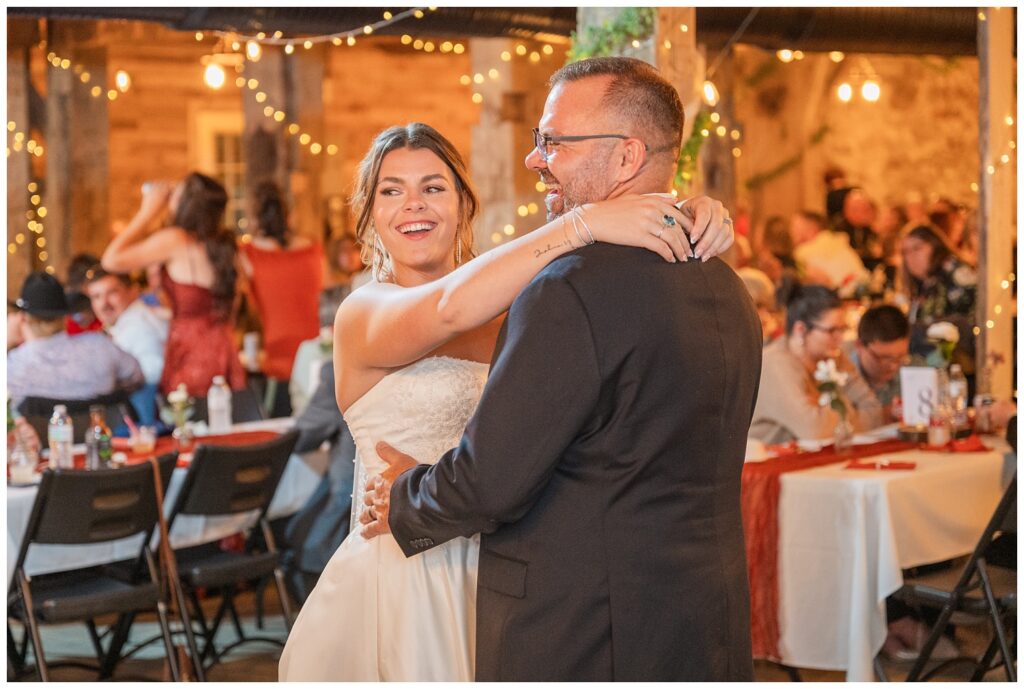 bride sharing a dance with her dad in the barn during fall wedding reception in Ohio