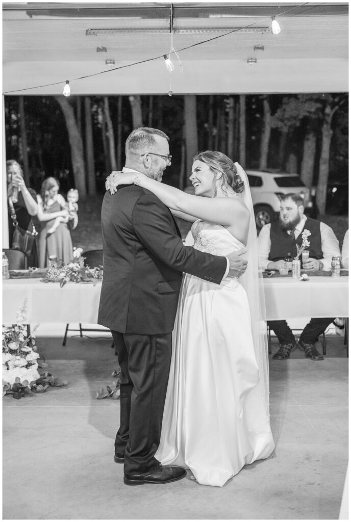 bride sharing a dance with her dad in the barn during fall wedding reception at Fremont, Ohio venue