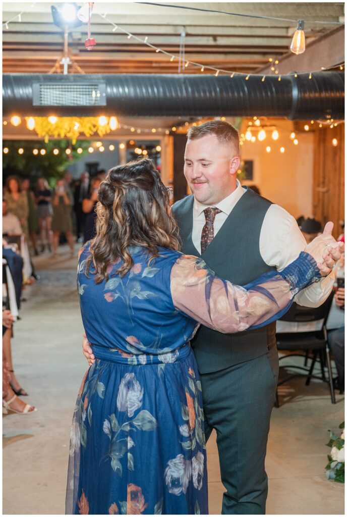 groom dancing with his mom in the reception barn at the Octagon House in Tiffin, Ohio