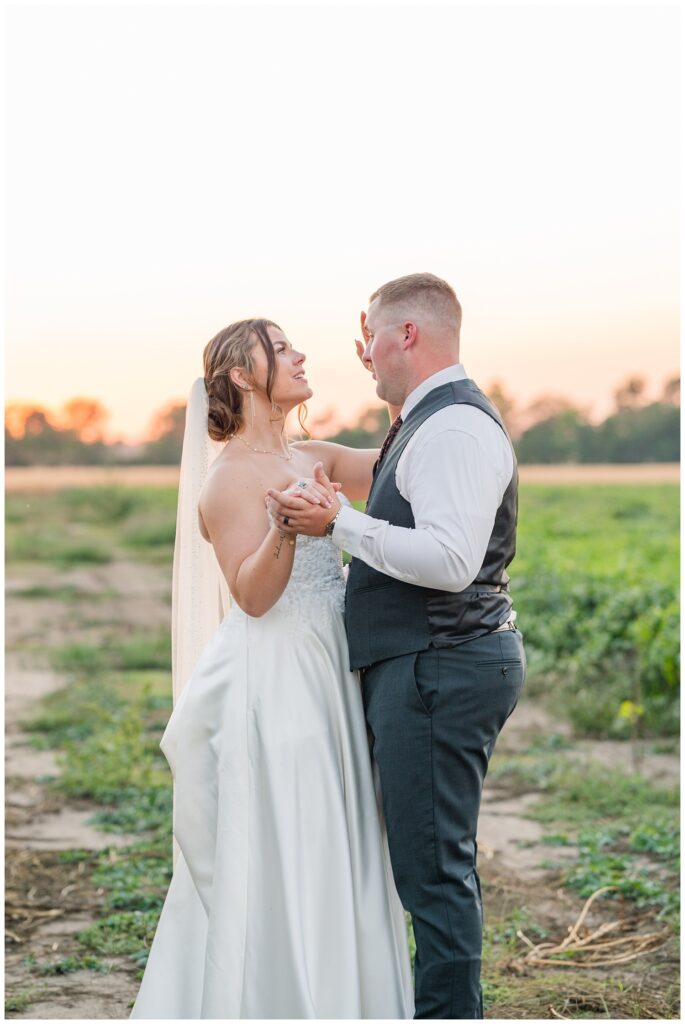 wedding couple dancing outside to the sunset in the background at Tiffin, Ohio venue