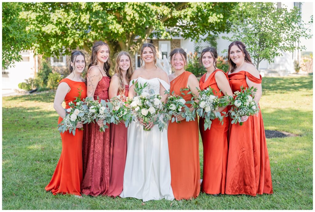 bridal party posing for portraits outside before the ceremony