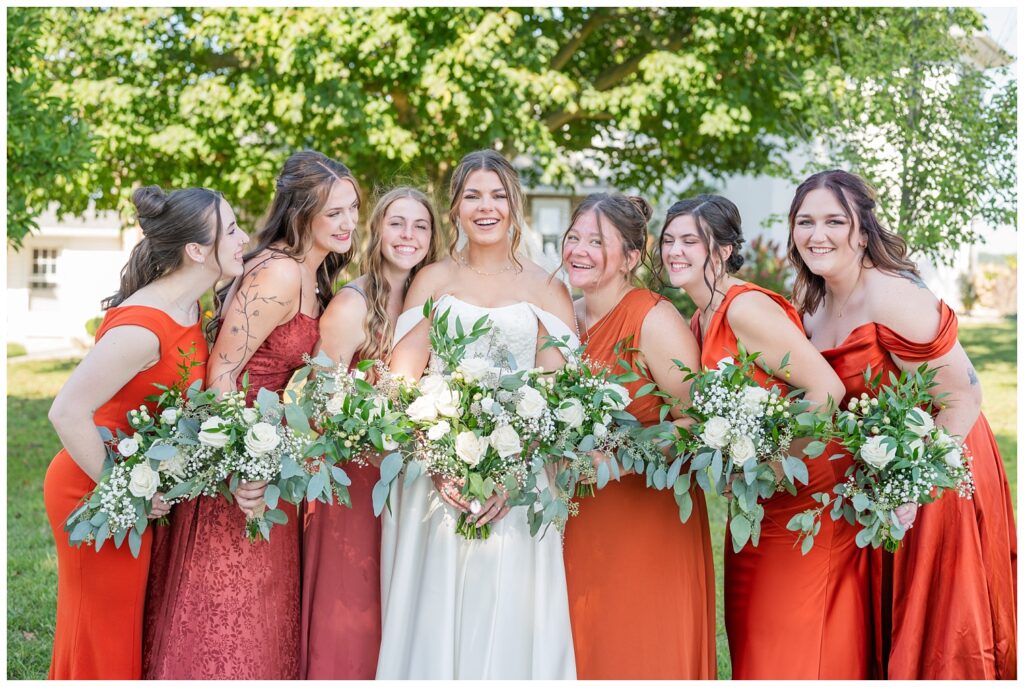 bridesmaids coming in for a close hug to the bride at Tiffin, Ohio wedding venue