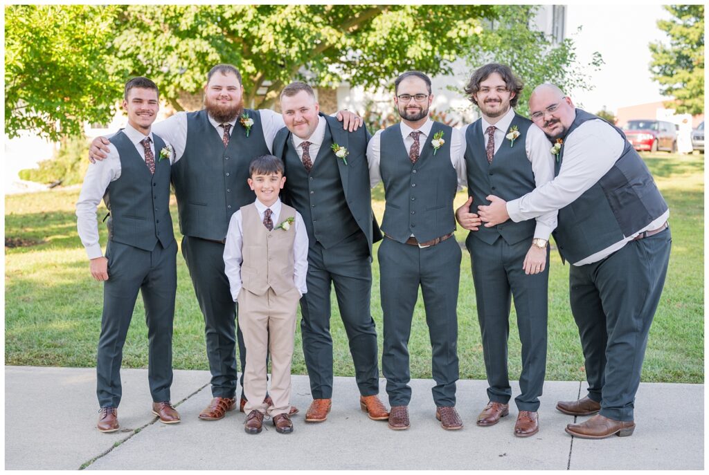 groomsmen posing together in gray suits at the Octagon House wedding venue