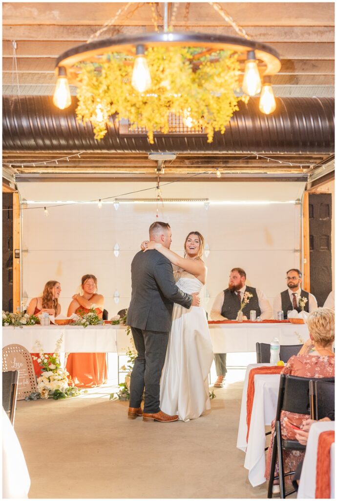 wedding couple dancing in front of the reception tables at Tiffin, Ohio venue in the fall