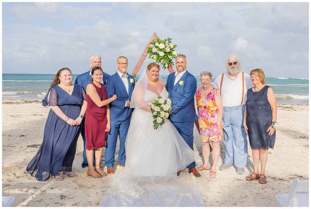 family portraits in front of the triangle decorated wood altar on Punta Cana resort beach