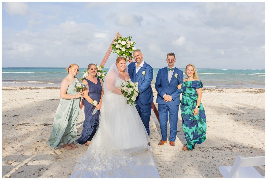 family portraits in front of the triangle decorated wood altar on Punta Cana resort beach