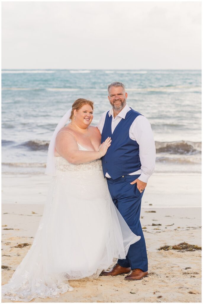 bride and groom posing on the beach for their wedding celebration at Punta Cana Dream Resort
