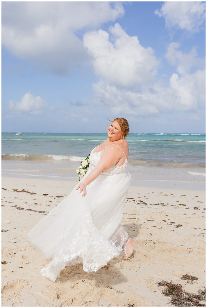bride twirling on the beach for Punta Cana destination wedding in the sun