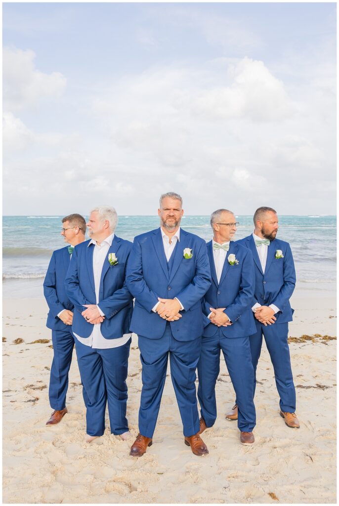 groomsmen posing together on the beach for Punta Cana destination wedding in the sun