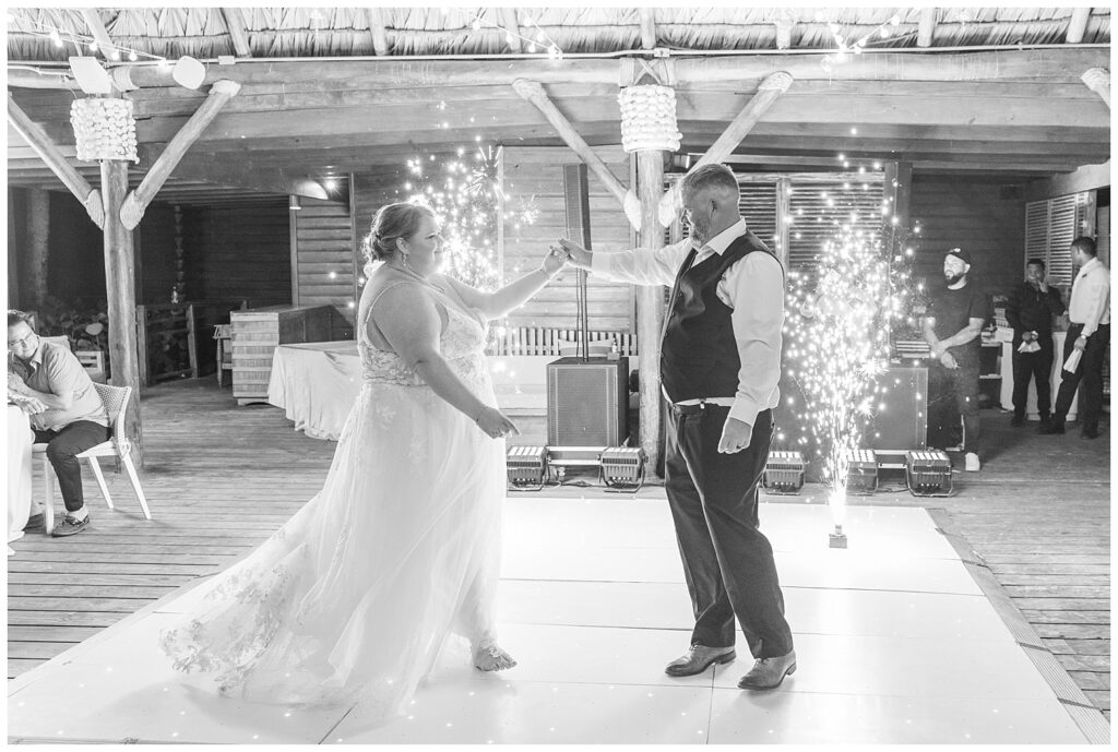 bride and groom starting to dance together surrounded by floor sparklers in Punta Cana