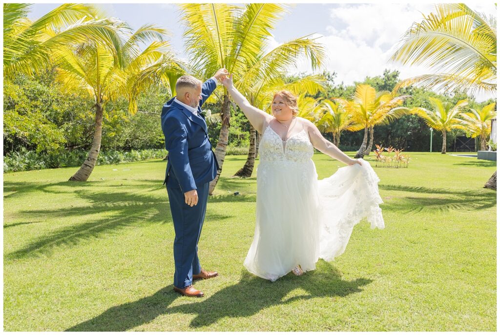 groom twirling bride during couples portraits at Punta Cana wedding in the fall                                                                                                                                                                                                                                                                                       
