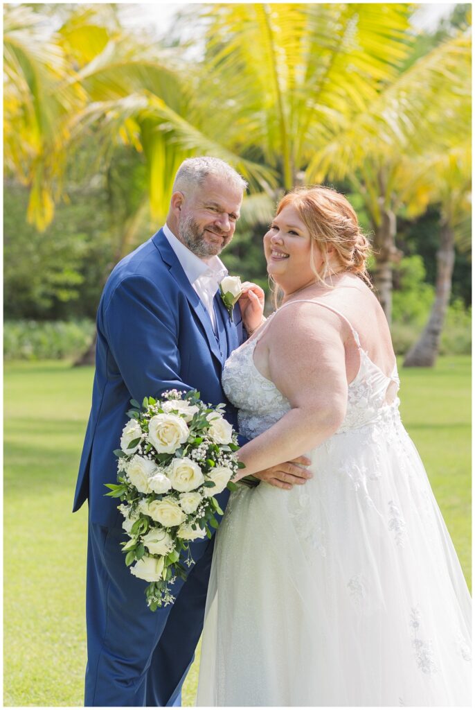 bride and groom laughing and smiling while posing for wedding portraits at Punta Cana resort 
