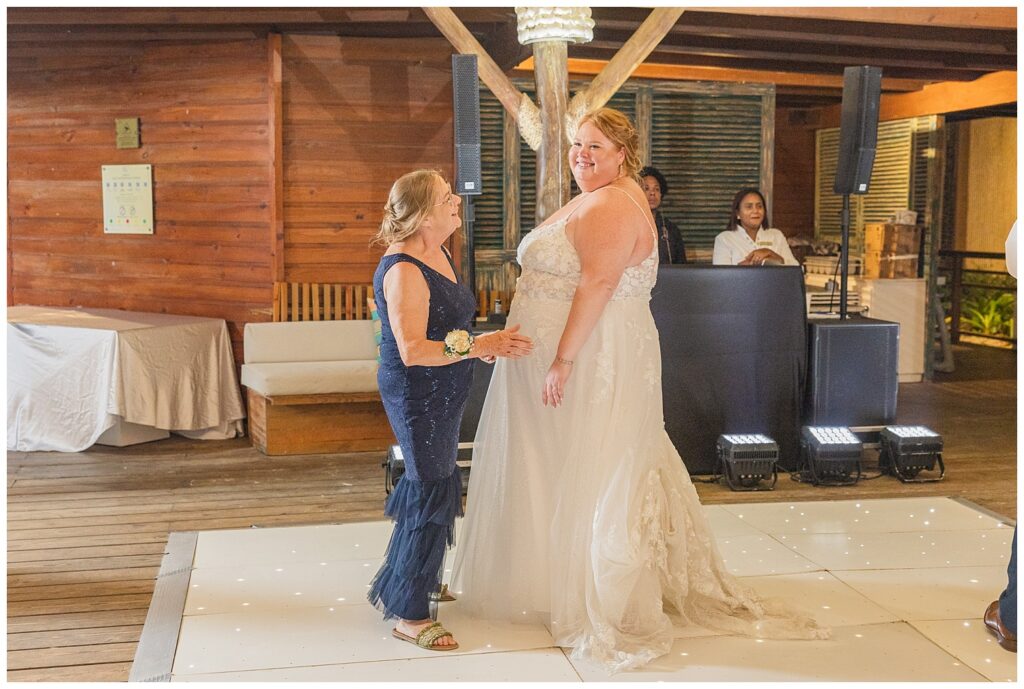 bride dancing with her mom on a white floor  at Punta Cana wedding reception