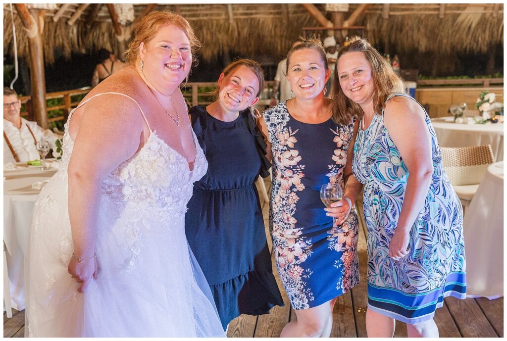 bride posing with the Tiffin, Ohio wedding photographer and other guests at Punta Cana reception