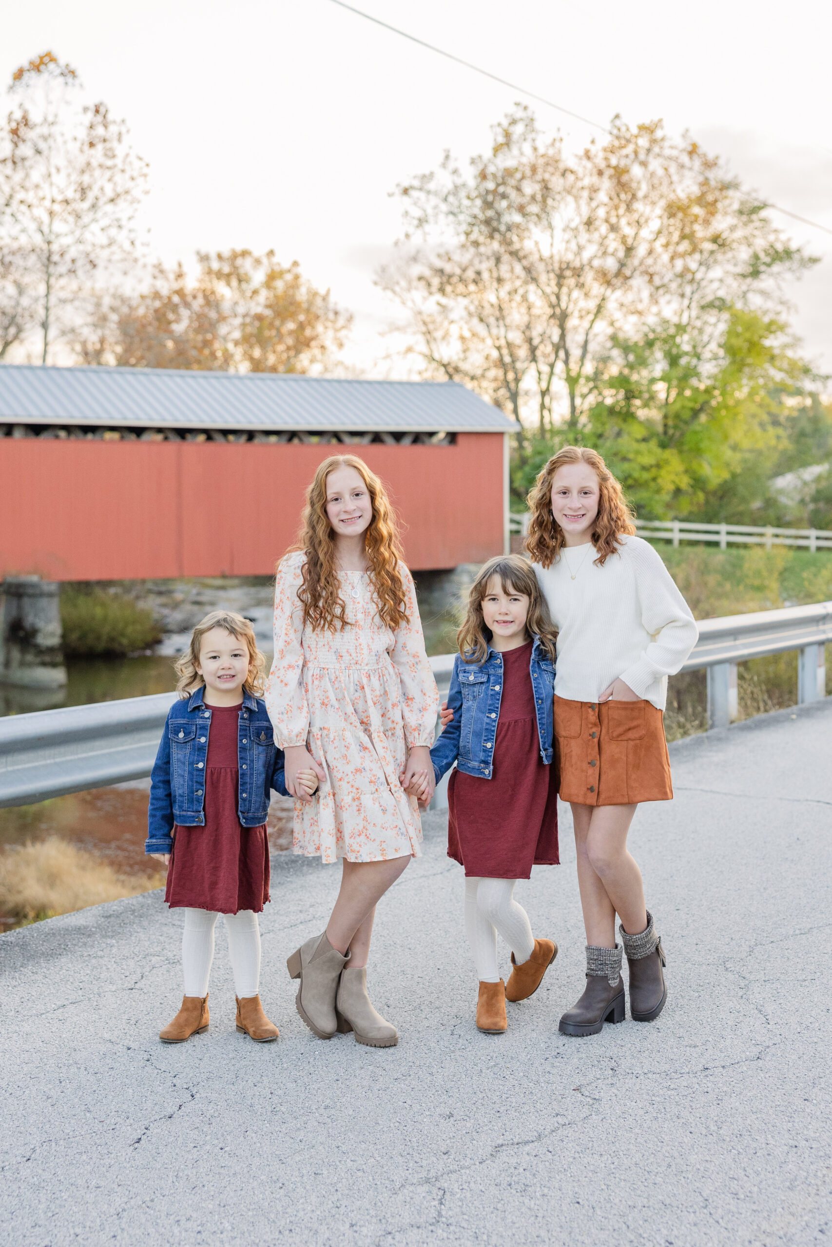 cousins posing together on the road near a red bridge in Fremont, Ohio