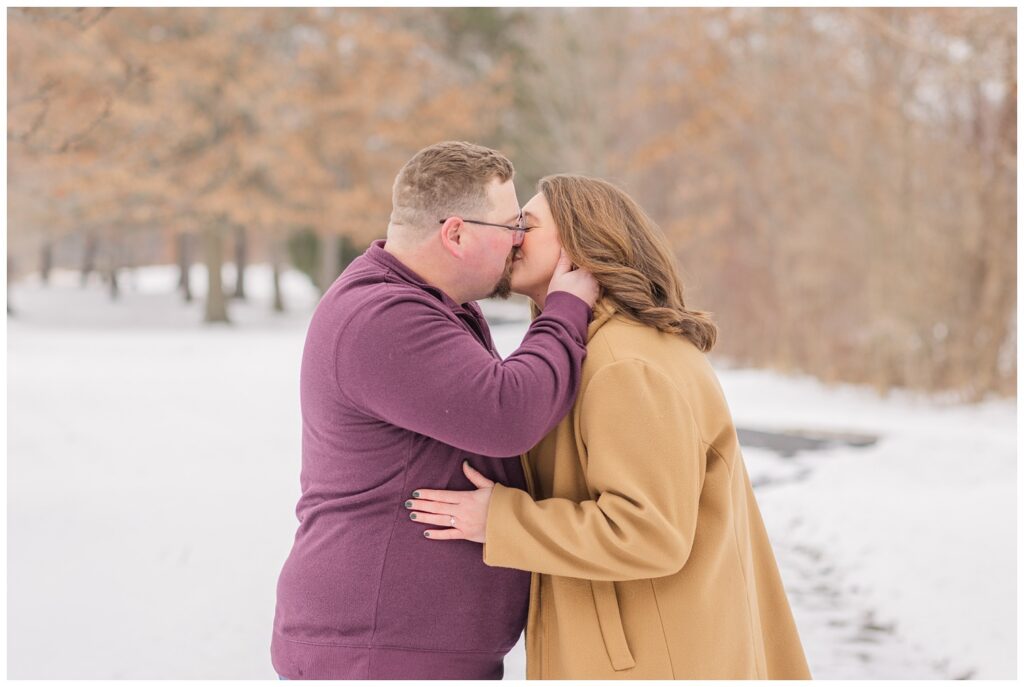 couple sharing a kiss and posing in the snow at Bloomfield, OH engagement session