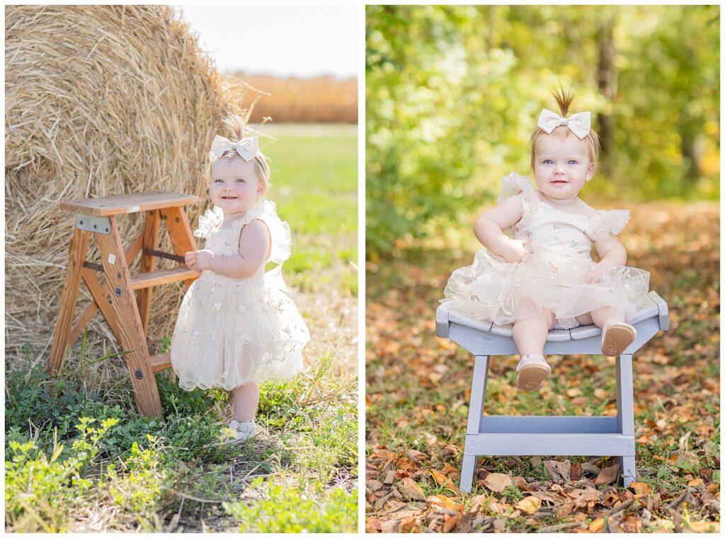 one year old girl sitting on top of a gray bench in the woods